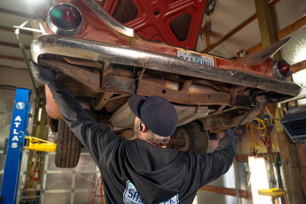 10 mil Pure Nitrile Gloves with Extended Cuff being used on an automotive repair