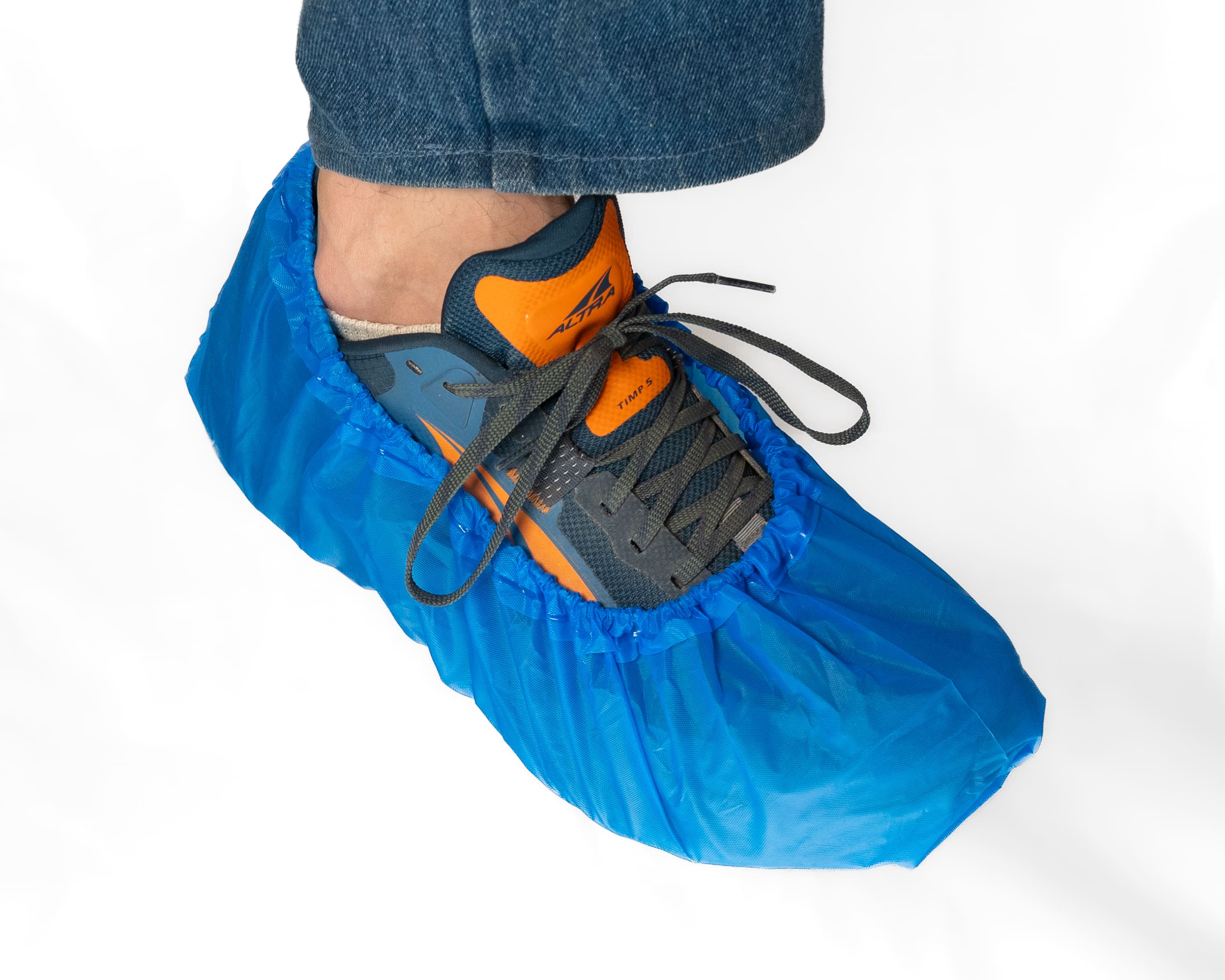 blue 503 PPE Non-Slip Shoe Covers covering a mans shoe with a white background